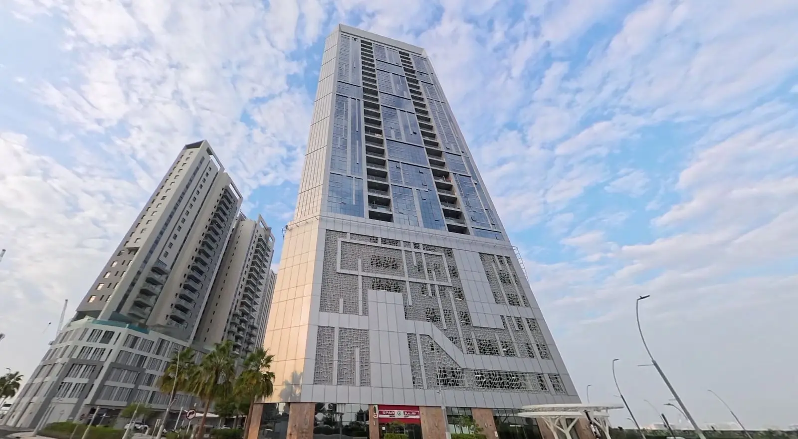 Scenic waterfront exterior view of Al Jeel Towers on Al Reem Island Abu Dhabi overlooking Arabian Gulf waters.