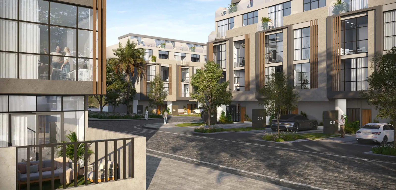 Gated community entrance with elegant townhouse exteriors at Reportage Village Khalifa City Abu Dhabi surrounded by palm trees and parks