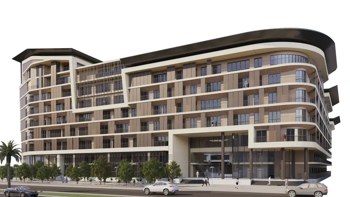 Contemporary twin-tower facade of Al Mahra Residence in Masdar City Abu Dhabi with modern architectural design.