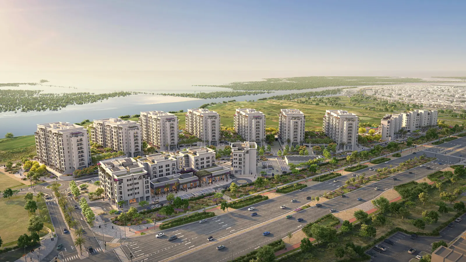 Aerial of Yas Golf Collection buildings nestled between golf course and mangroves.